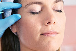 Woman receiving an injection in her face